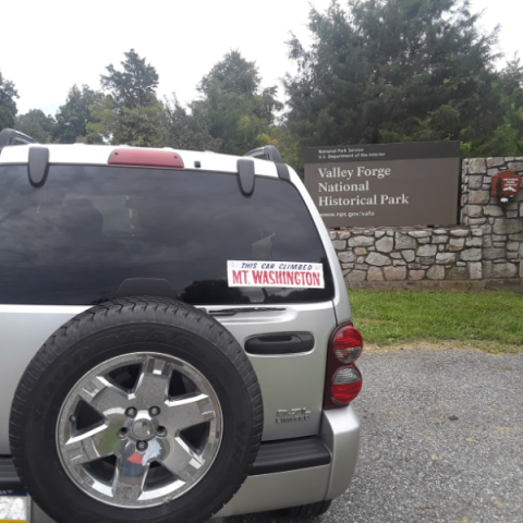 a truck is parked in front of a car