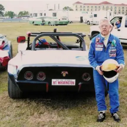a person standing in front of a car