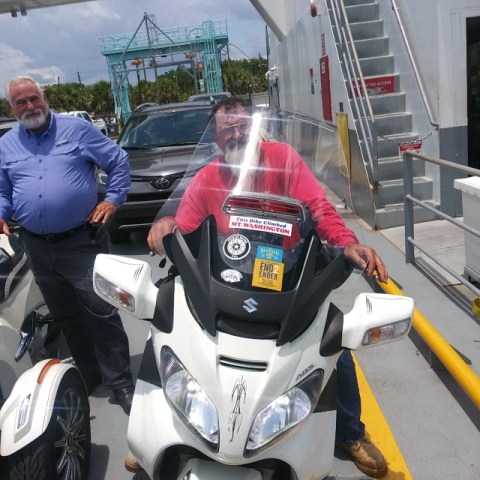 a group of people riding on the back of a motorcycle