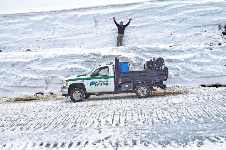 a group of people riding skis down a snow covered field