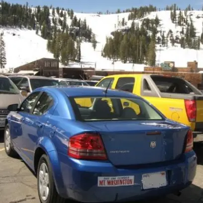 a car parked on the side of a snow covered road