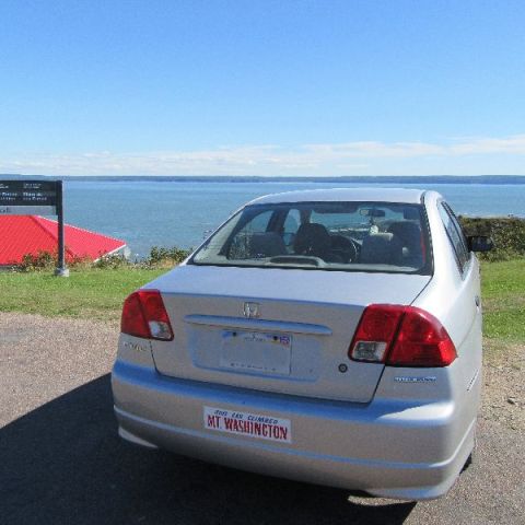 a car parked next to a body of water