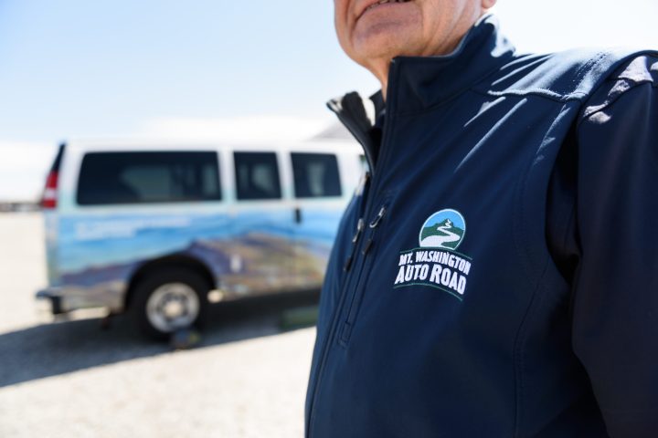 a man standing in front of a car