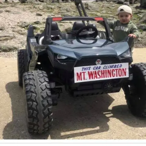 a close up of a toy car on a dirt road