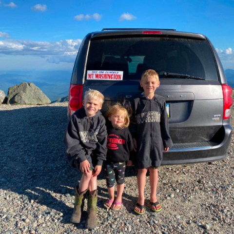 a man standing next to a child in a car