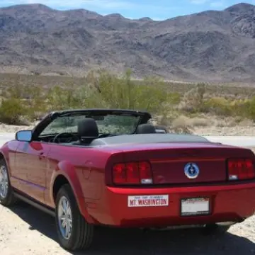 a car parked on the side of a dirt road