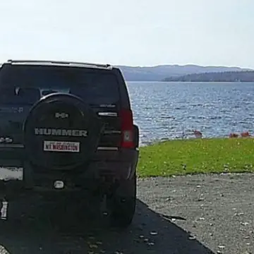 a car parked next to a body of water