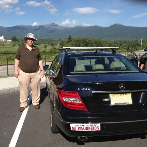 a man standing in front of a car