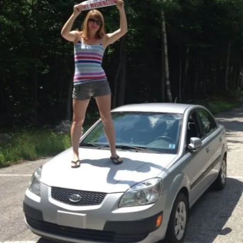a person riding on the back of a car
