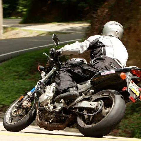 a person riding a motorcycle on the side of a road