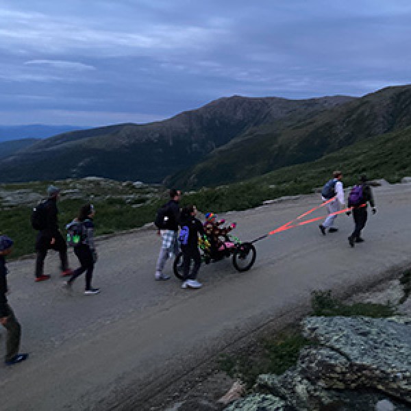 a group of people on a mountain road