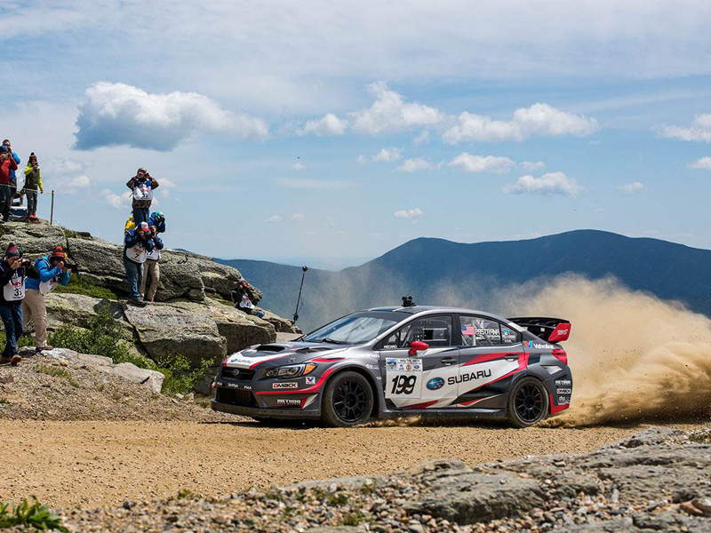 a person riding a motorcycle down a dirt road