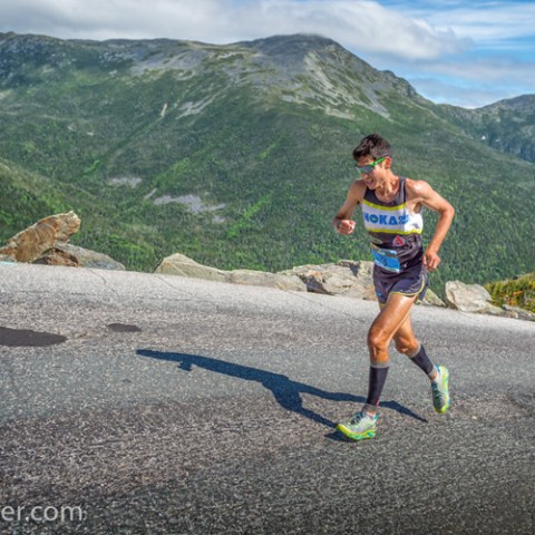a man riding on top of a mountain road