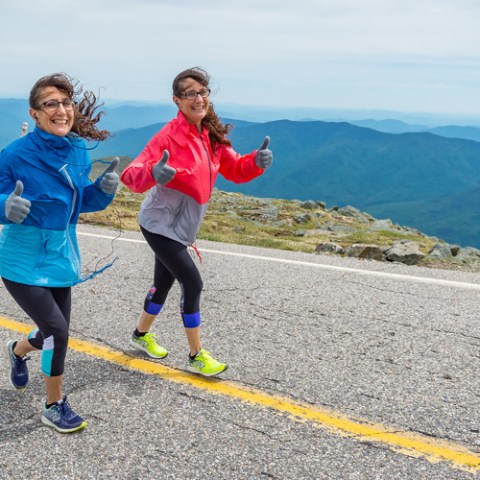 a young boy standing on a mountain road