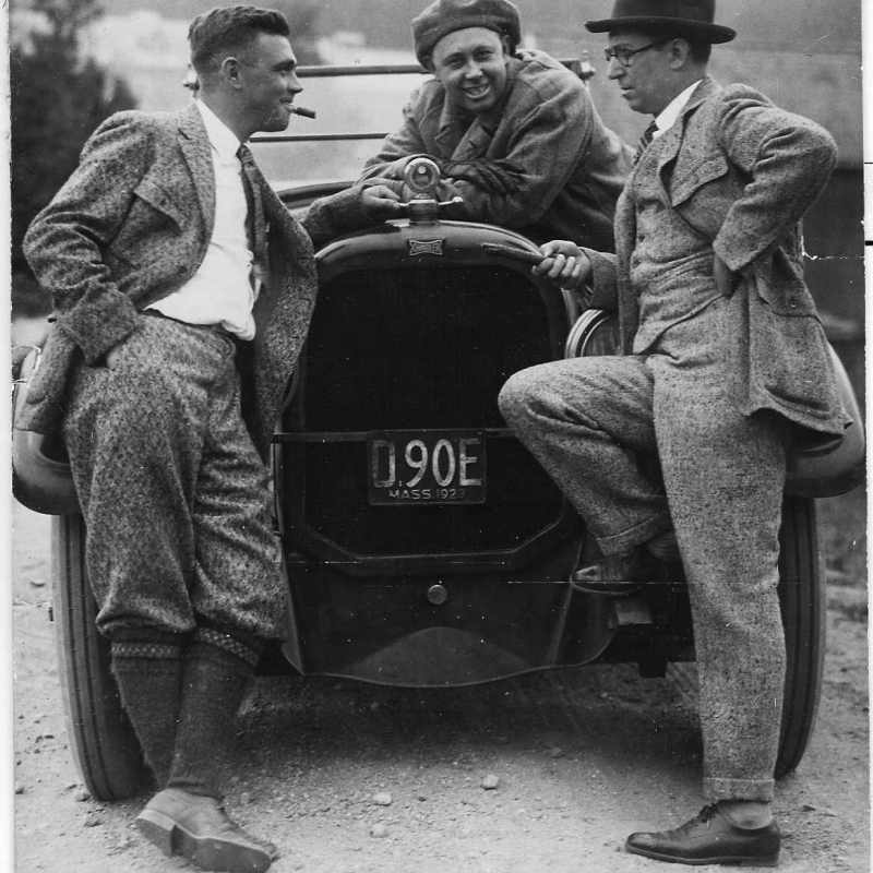 Ralph Mulford et al. riding on the back of a truck