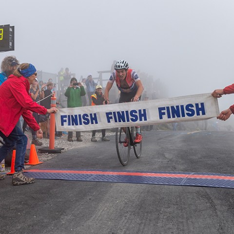a group of people riding skis on a snowy road