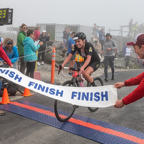 a group of people riding skis on a snowy road