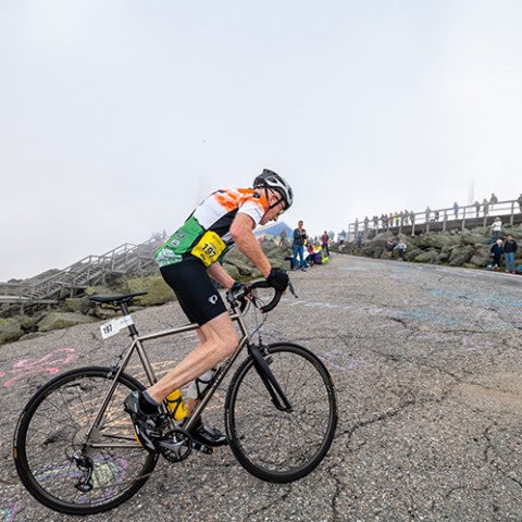 a man riding on the back of a bicycle