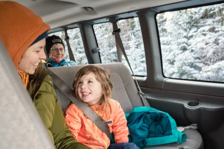Family smiling on snowy winter tour guide