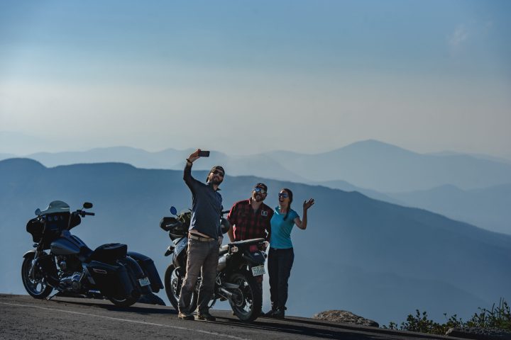 a group of people standing on top of a mountain