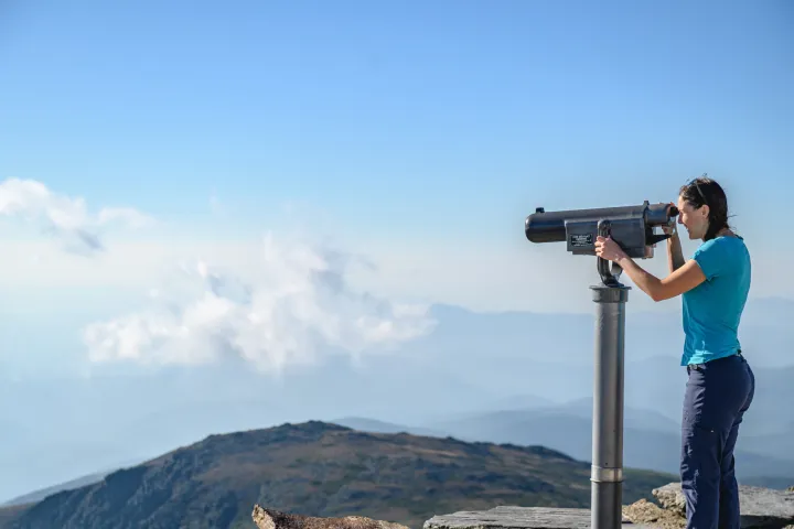a person standing in front of a mountain