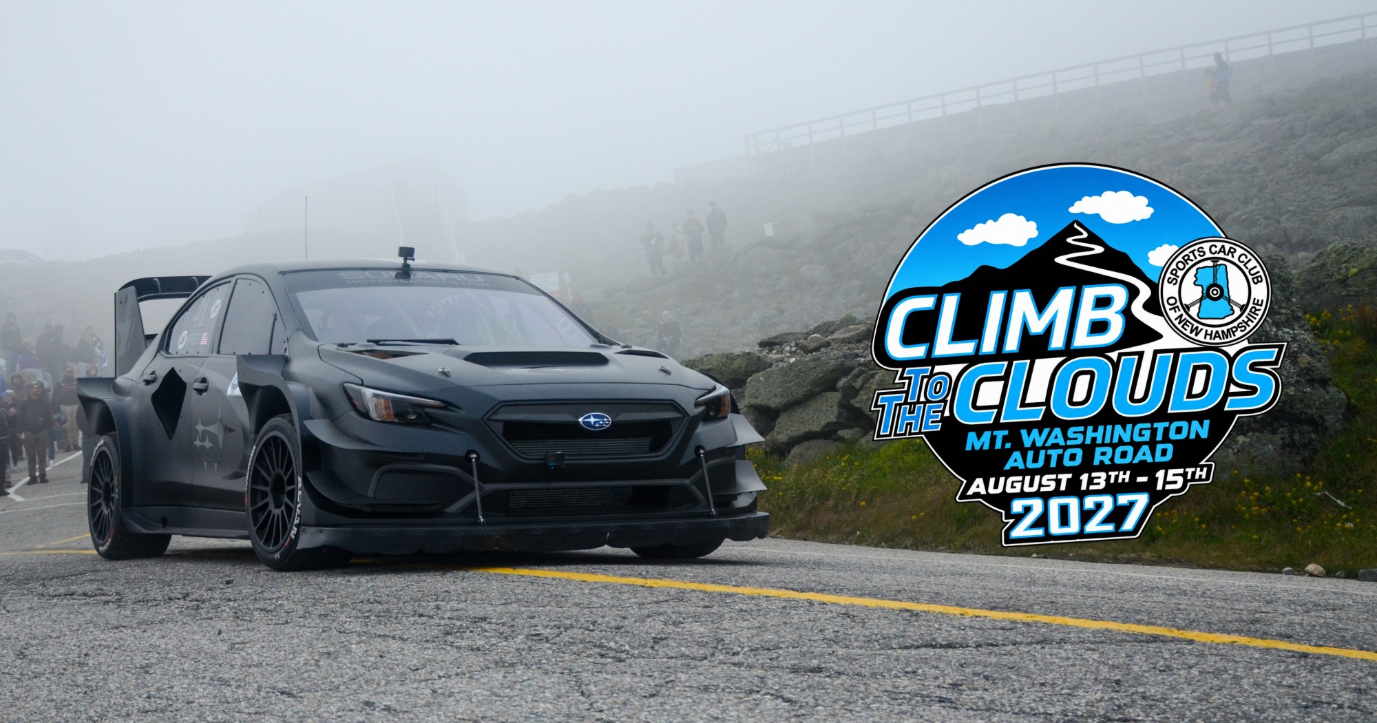 Rally car on mountain road with 'Climb to the Clouds 2027' logo.